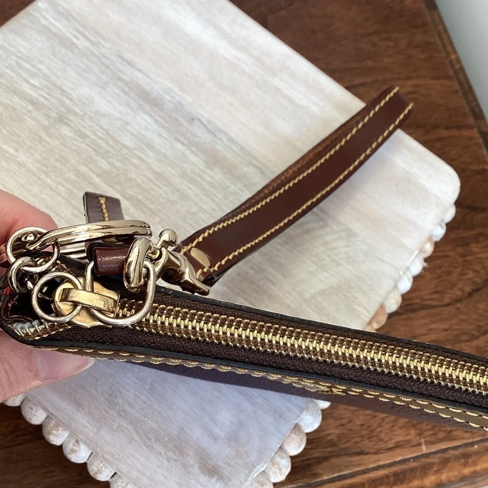 Dooney & Bourke pebbled deep purple and Brown Leather Wristlet, keychain